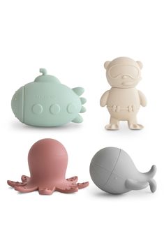 four different toys are shown in the shape of an octopus, whale, and squid