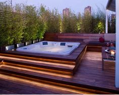 a hot tub sitting on top of a wooden deck