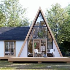 a - frame house in the woods with an open floor plan and large windows on each side