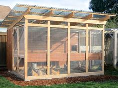 a chicken coop in the middle of a yard