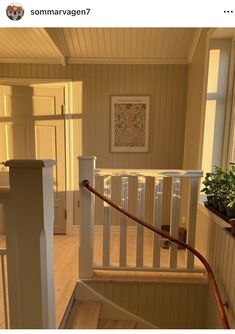 the stairs in this house are made of wood and have handrails that lead up to the second floor