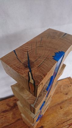 a clock made out of wood on top of a wooden table