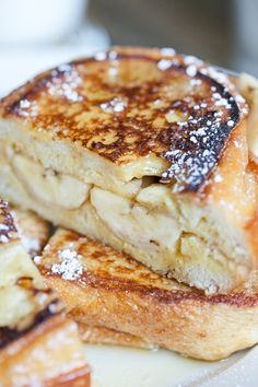 two pieces of french toast stacked on top of each other with powdered sugar on them