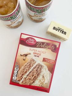 two cups of ice cream next to a package of cake mix