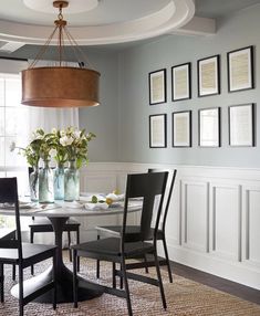 a dining room table with chairs and pictures on the wall above it, along with an instagram