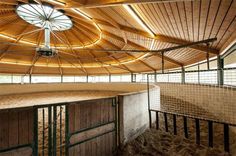 the inside of a barn with several stalls