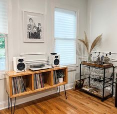 an old record player sits on top of a shelf in the corner of a room