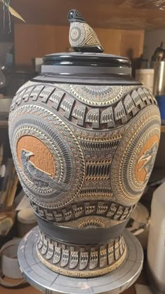 a large vase sitting on top of a wooden table