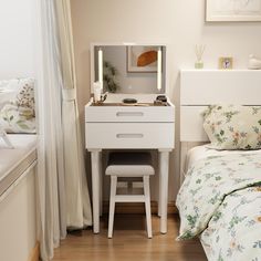 a bedroom with a bed, desk and mirror