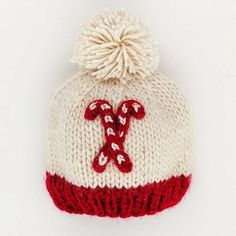 a white and red knitted hat with candy canes on it