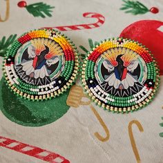 These are earrings I beaded myself, green, bone, yellow, orange, red, and blue beads surrounding a cabochon in the center, the back is black leather (presumably cow) and the earring facet is a stud.  These are hand made, if you send them in for repair they may go back to you looking slightly different ❤️ Medallion Earrings, Native Beading, Beading Inspiration, Native Beadwork, Nativity Crafts, Beaded Earrings Patterns, Beading Ideas, Native Jewelry, Native American Beading