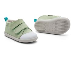 a pair of green shoes with white soles