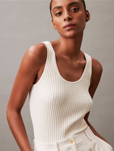 Accentuated with ribbed texture throughout, this tank top is crafted from 100% cotton for total, breathable comfort. Made with a scoopneck and cut with a slightly relaxed fit.  Material: 100% Cotton. Classic Calvin Klein Tops For Everyday, Calvin Klein Everyday Summer Tops, White Ribbed Casual Tank Top, White Ribbed Tank Top, Casual Style, Casual White Ribbed Tank Top, Calvin Klein Spring Tops For Everyday Wear, Calvin Klein Tops For Everyday Summer Wear, Chic Ribbed Crew Neck Tank Top, White Ribbed Crew Neck Tank Top