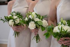 the bridesmaids are holding their bouquets in their hands