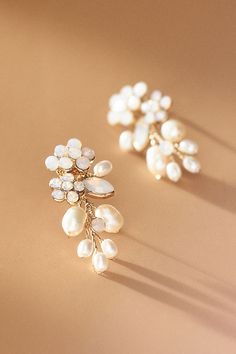 two pairs of pearl and gold - plated earrings, one with leaves on it