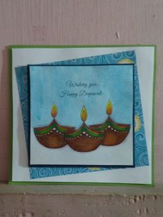 a birthday card with three lit candles on it