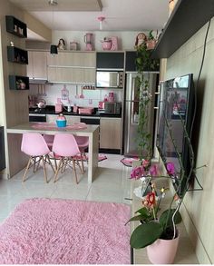 a pink rug in the middle of a kitchen