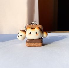 a small figurine is sitting on top of a piece of bread that has been placed in the shape of a cat