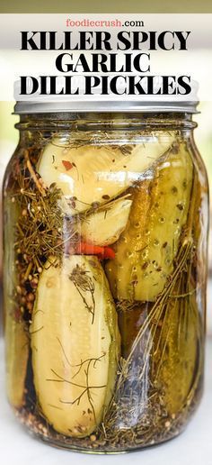 a jar filled with pickles sitting on top of a table