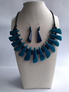 Blue tagua necklace and earrings set. Jewelery blue necklace. Totally Handmade. Natural and Organic Jewelry. Free Shipping Handmade adjustable neacklace. Handcrafted from tagua seeds from Colombian rainforest. Pure and organic.  Perfect for women's special occasion. Gift for her, casual, formal, and dress up.  The entire length of the necklace is 15.7 inches long (40 cm), the pendant horizontal lenght is 6.1 inches (15.6 cm) and the witdh of each bead is 1.37 inches (3.5 cm). Pull it looser or t Handmade Blue Dangle Jewelry Sets, Handmade Blue Jewelry Sets With Dangle Shape, Blue Fair Trade Jewelry, Handmade Blue Jewelry Sets For Gifting, Turquoise Fair Trade Jewelry For Gifts, Handmade Blue Jewelry Sets As Gift, Fair Trade Turquoise Jewelry Gift, Adjustable Blue Fair Trade Necklace, Artisan Blue Jewelry With Fair Trade