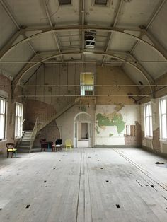 an empty room with wooden floors and exposed ceilings