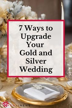 gold and silver wedding table setting with white flowers, candles and napkins on it