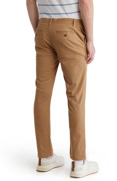 A solid hue makes these chino pants a versatile, everyday classic staple for your closet. 9" rise, 32" inseam (size 32x32) Trim fit Zip fly with button closure 2 front slash pockets; 2 back button welt pockets 97% cotton, 3% spandex Machine wash, tumble dry Imported Slim Fit Tapered Leg Chinos For Business Casual, Fitted Chino Cotton Twill Chinos For Spring, Business Casual Tapered Leg Chinos With Welt Pockets, Slim Fit Straight Leg Solid Chinos, Slim Fit Cotton Chinos With 5-inch Inseam, Solid Chino Cotton Twill Straight Pants, Solid Color Slim Fit Straight Leg Chinos, Slim Fit Straight Leg Chinos, Chino Cotton Twill Bottoms For Workwear