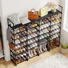 a shoe rack filled with lots of shoes next to a rug on the floor in front of a window