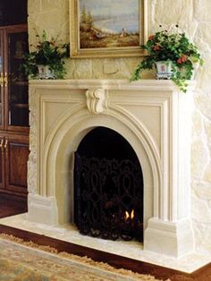 a living room with a fire place next to a painting on the wall above it