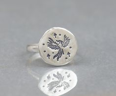 Sterling silver tiny Phoenix ring Artisan handmade  Rustic style 14 gauge sterling silver half round band -Size of Charm: 12 mm -Please choose your size at check-out All metals used: 925 sterling silver, 999 fine silver, 14K gold All gemstones are semiprecious All of my jewelry comes nicely packaged I am open to making custom pieces Please click here to visit shop: https://www.etsy.com/shop/NatureJourney Thank you for visiting! Adjustable Sterling Silver Spiritual Signet Ring, Phoenix Ring, Magic Jewelry, Bird Ring, Ring Moon, Phoenix Bird, Moon Ring, Style Rustique, Handmade Artisan