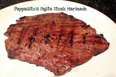 a piece of steak on a plate with the caption papasit's fajita steak marinade