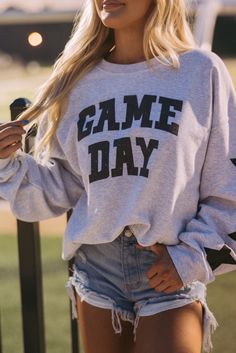 Our Game Day Graphic Sweatshirt is sure to keep you stylish and cozy Perfect for cheering on your favorite team or lounging at home The eye-catching graphic print adds a fun and unique touch With its relaxed fit and ribbed cuffs, this sweatshirt offers a comfortable and flattering silhouette Coffee Shop Merch, Crewnecks For Women, Football Gf, Hockey Crafts, Baseball Game Outfit, Trendy Mom Outfits, Football Clothes, Fashion Jumpsuits, Tana Mongeau