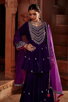 Purple short kalidar kurta with dori embroidery. Comes with gharara and a dupatta.
Component: 3
Pattern: Embroidered
Type Of Work: Dori
Neckline: Round
Sleeve Type: Full
Fabric: Velvet, Organza
Color: Purple
Other Details: 
Embroidered yoke and sleeves
Note : Necklace worn by the model is not for sale.
Occasion: Mehendi and Haldi, Sangeet - Aza Fashions Lehenga Design For Engagement, Lehenga Images, Lehenga Online Shopping, Gharara Suits, Maharani Designer Boutique, Pink Anarkali, Designer Bridal Lehenga, Embellished Shorts, Lehenga Online