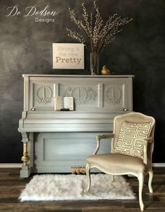 a chair sitting next to a piano in front of a wall with writing on it