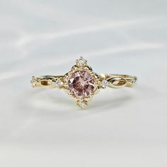 a ring with a pink diamond in the center