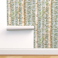 the wall paper has been designed to look like birch trees with green leaves on them