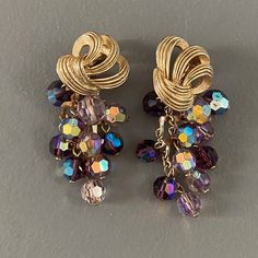 "These earrings are sumptuous and very glamorous, the dangling faceted crystal beads reminding me of grapes. These are beautifully made using quality materials. An unusual design. Rare find! Measure 2\" L x 1\" W. In excellent condition." Elegant Purple Crystal Earrings With Dangling Beads, Purple Drop Crystal Earrings For Evening, Purple Crystal Drop Earrings For Evening, Elegant Purple Beaded Earrings With Faceted Beads, Purple Dangling Beads Party Earrings, Elegant Purple Crystal Bead Earrings, Elegant Purple Round Bead Crystal Earrings, Purple Dangling Beads Earrings For Party, Purple Dangling Beads Crystal Drop Earrings