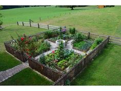 an aerial view of a garden in the middle of a field