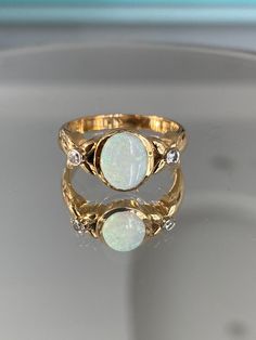 Stunning New! Luxury Custom Jewellery 18K Karat Solid Yellow Gold Triple A Grade Opal & Diamond Ladies Statement Ring Womens Gift For Her 6.8 grams total weight of the ring Ring Size: 8 and 1/2 (Adjustable to any ring size) Oval Cut Bezel Set Triple AAAA High Grade Opal & 2 Small Diamonds Jewelry Appraisal Available Upon Request (+60$ CAD) Please take a look at this similar matching necklace listing for the complete set:  https://www.etsy.com/ca/listing/1162995408/new-ladies-triple-opal-18k-karat-yellow?click_key=7aeaf89fa5ed1281333a626594517b36d4f82b2b%3A1162995408&click_sum=f414679b&ref=shop_home_active_23&pro=1&frs=1 Gold Opal Ring Stamped 14k, Gold Opal Ring With 17 Jewels, Formal Gold Opal Ring Stamped 14k, Heirloom Gold Opal Ring Stamped 14k, Classic Gold Opal Ring With 17 Jewels, Classic Gold Opal Ring Stamped 14k, Gold Opal Ring With Diamond Accents For Formal Occasions, Formal Gold Opal Ring With Diamond Accents, Luxury Opal Ring With Bezel Setting