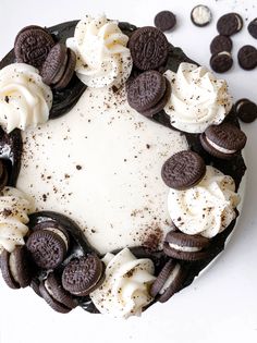 an oreo cookie cake with white frosting and cookies around it