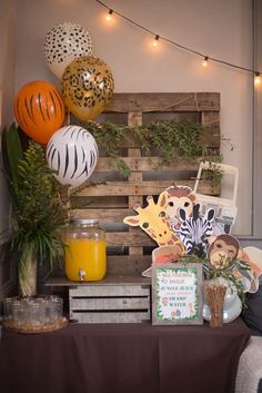 a table topped with lots of different types of balloons and decorations on top of it