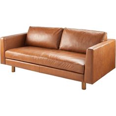 a brown leather couch sitting on top of a white floor next to a wooden frame