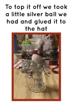 a christmas card with an image of a snowman in a glass vase on top of a table