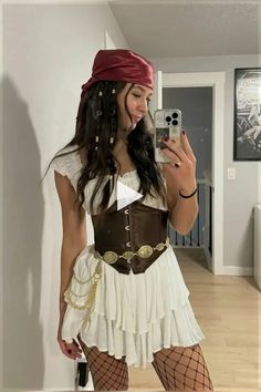 a woman in a pirate costume taking a selfie