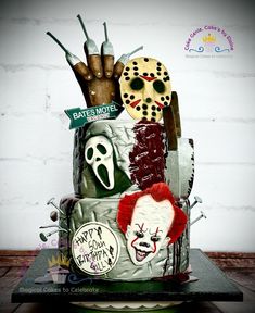 a cake decorated to look like it has scary masks on top