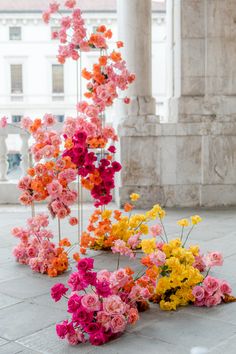 many different colored flowers are arranged on the ground