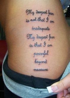 a woman with a tattoo on her stomach saying, my deepest fear is not that i am