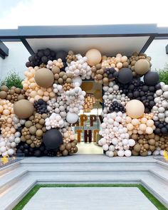 an entrance decorated with balloons and greenery