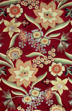 a red rug with flowers and leaves on it