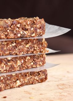 three pieces of granola are stacked on top of each other with a knife in the middle